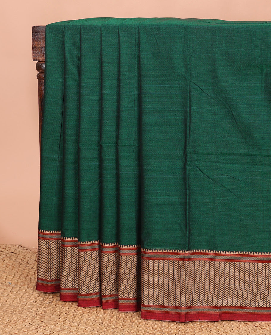 Dark green plain Narayanapet cotton saree, contrast geometric patterned thread border, and striped pallu