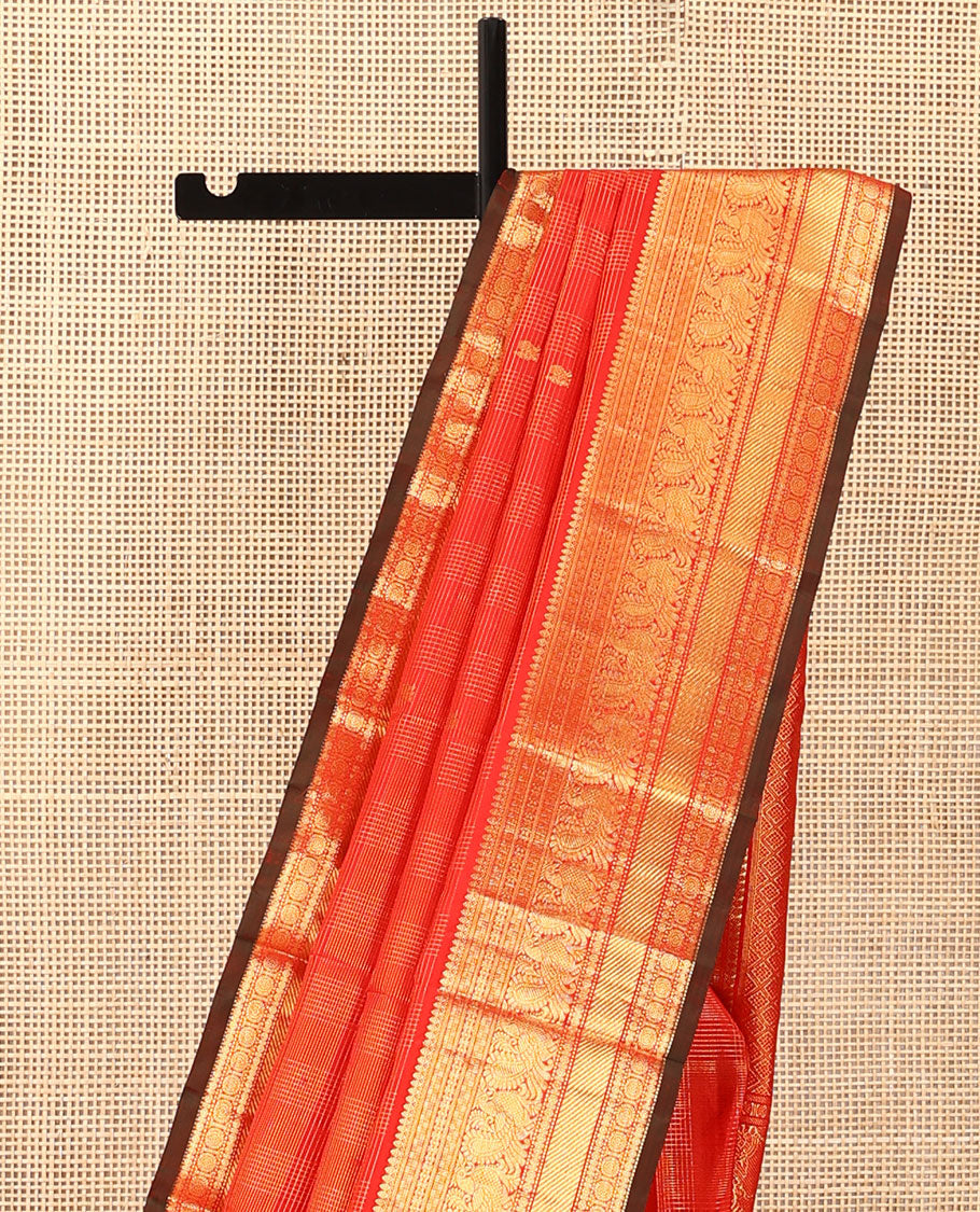 Red zari checked and buttas Kanchipuram silk saree, zari border of thilakam mokku, banaras, kamalam, mayil, and chakram designs, and jaal pallu