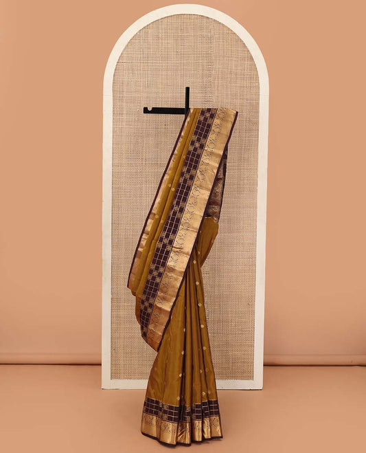 Mustard zari buttas Vasundhara silk mix saree, contrast annam chakram enclosed zari checked border of rekku, kamalam, arumbu manga, and yaanai, and jaal pallu