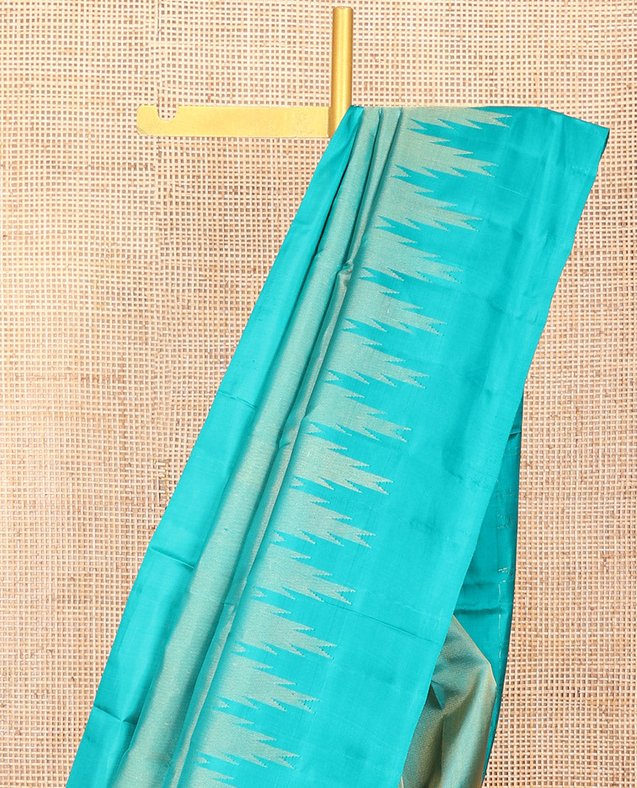 Blue Vasundhara Silk Saree Gleamed Up with Thazampoo Rekku Border, Pallu of Manga, Kodi Visiry, and Thazampoo Rekku Designs, and Paired with a Matching Blouse