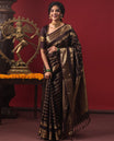 Brown Vasundhara Silk Saree, Enriched with Annam Chakram Buttas and Zari Stripes, Highlighted by Zari Rettai Pettu Border of Ara Bogudi, Muthu, Banaras, Yaanai, and Chakram Designs, Gleaming Jaal Design Woven Pallu, and Paired with a Matching Blouse