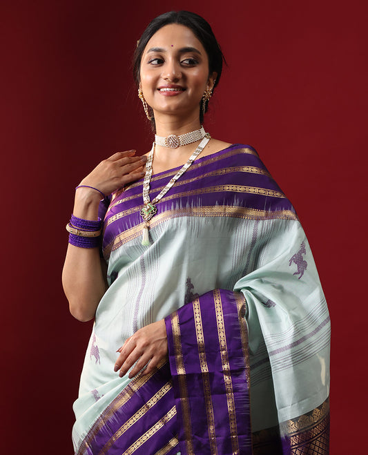 Blue Kanchipuram Silk Saree, Delicately Woven with Deer Buttas All Over Its Body, Complemented by a Contrast Varisai Pettu Border of Muthu, Rudraksham, and Mayil Kann Designs, Grand Jaal Pallu, and Paired with a Contrast Blouse
