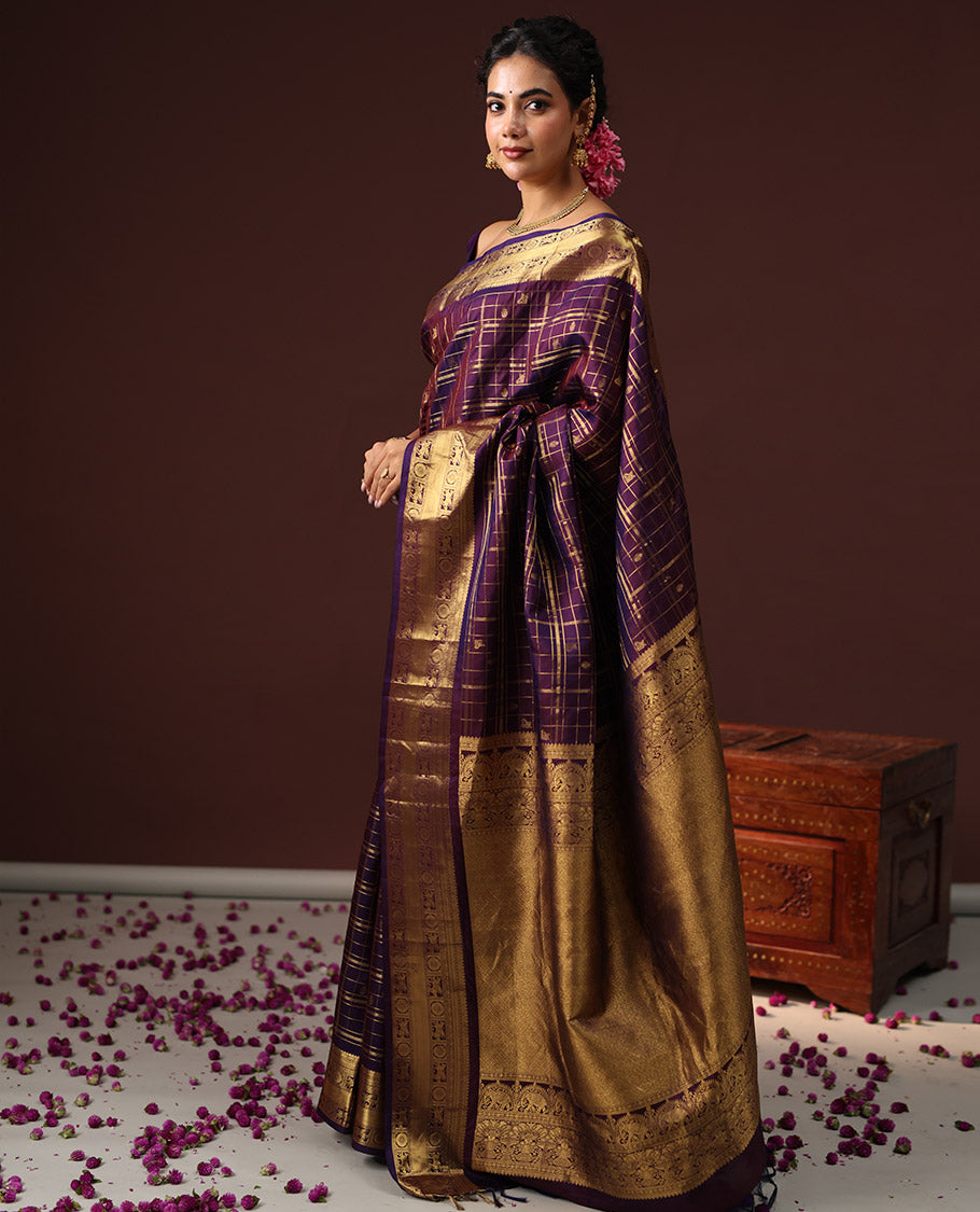 Purple Vasundhara Silk Saree Spotlighted with Zari Butta Enclosed Checks, Highlighted by a Zari Border of Kuthirai and Chakra Designs, Pallu Complemented by Zari Rich Weave, and Paired with a Matching Blouse