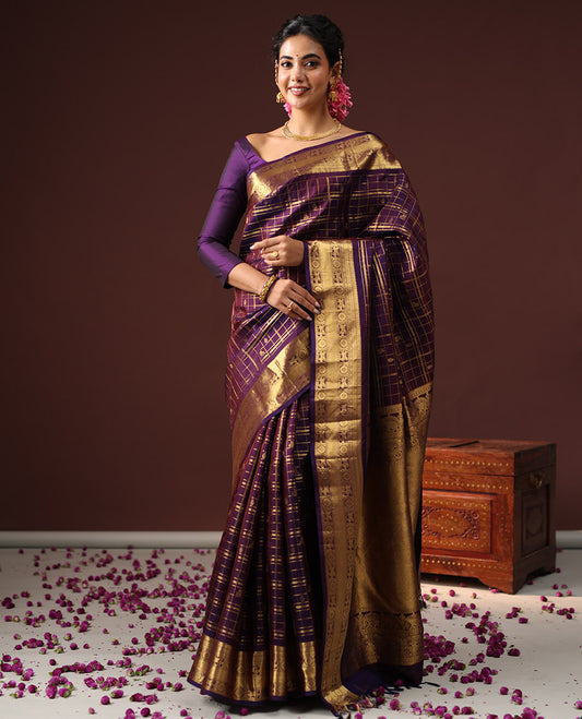 Purple Vasundhara Silk Saree Spotlighted with Zari Butta Enclosed Checks, Highlighted by a Zari Border of Kuthirai and Chakra Designs, Pallu Complemented by Zari Rich Weave, and Paired with a Matching Blouse