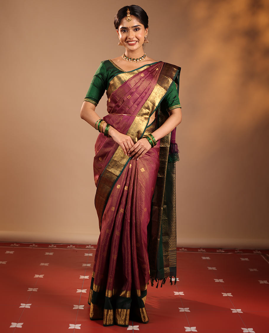 Magenta Vasundhara Silk Saree Featuring Zari Checks and Annam Chakram Buttas, Complemented by a Contrast Rettai Pettu Border with Muthu, Yaali, and Kodi Visiry Designs, a Jaal Pallu, and a Contrast Zari-Bordered Blouse