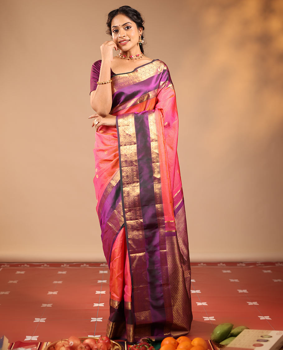 Orange Vasundhara Silk Saree Featuring Zari Checks and Annam Chakram Buttas, Complemented by a Contrast Rettai Pettu Border with Muthu, Yaali, and Kodi Visiry Designs, a Jaal Pallu, and a Contrast Zari-Bordered Blouse