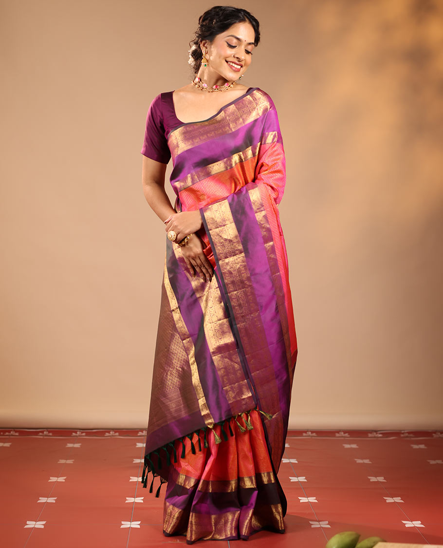 Orange Vasundhara Silk Saree Featuring Zari Checks and Annam Chakram Buttas, Complemented by a Contrast Rettai Pettu Border with Muthu, Yaali, and Kodi Visiry Designs, a Jaal Pallu, and a Contrast Zari-Bordered Blouse