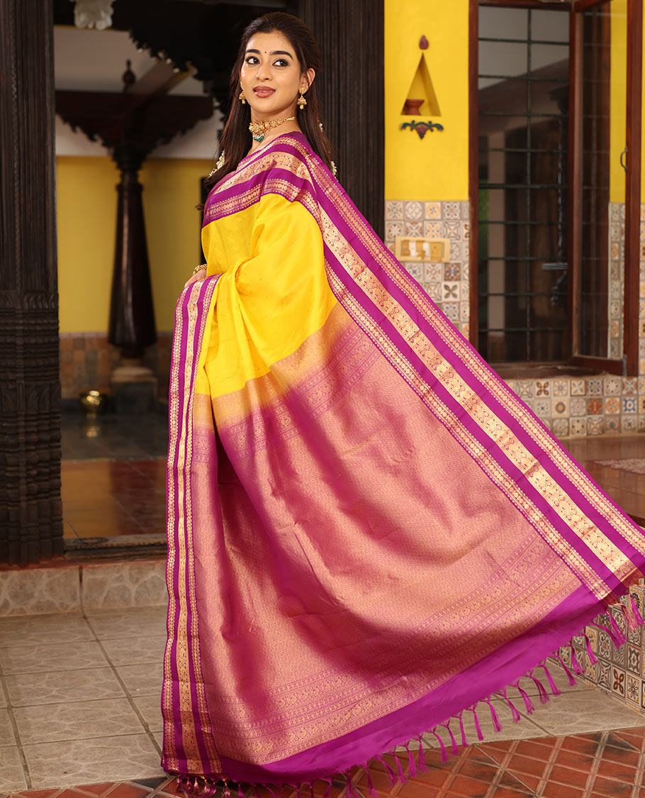Yellow Vasundhara Silk Saree Finely Woven with Zari Buttas, Complemented with Varisai Pettu Border Featuring Rekku, Muthu, Banaras, Rudraksham, and Mayil Designs, Majestically Zari-Woven Pallu, and a Contrast Blouse