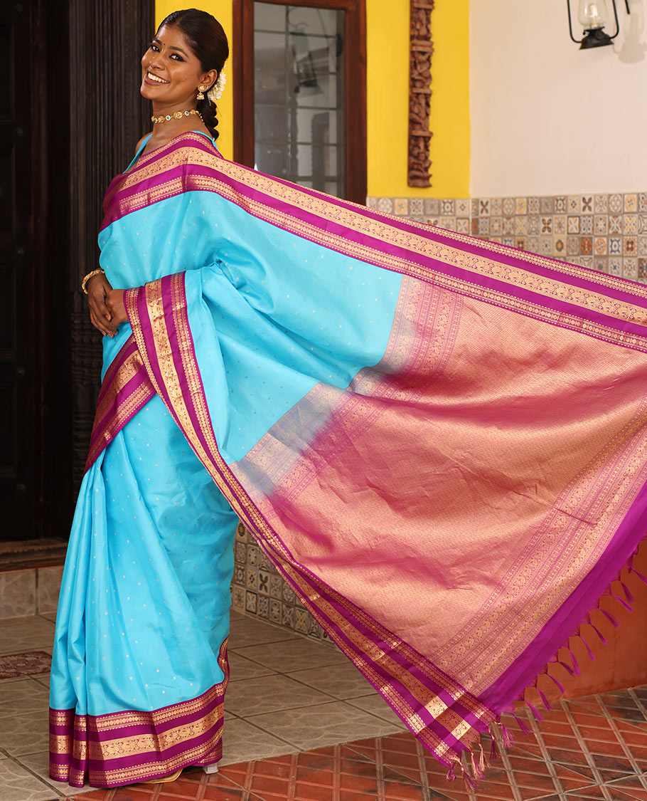 Blue Vasundhara Silk Saree Gracefully Embellished with Zari Buttas, Complemented by a Varisai Pettu Border Featuring Rekku, Muthu, Banaras, Rudraksham, and Mayil Designs, Majestically Woven with a Zari-Designed Pallu, and Paired with a Contrast Blouse