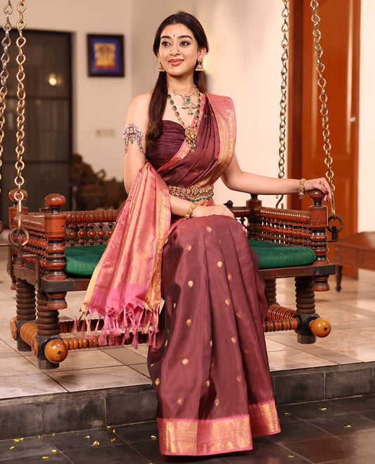 Brown Vasundhara Silk Saree Enriched with Zari Buttas, Complemented by a Contrast Border Featuring Auspicious Pichwai Cow Designs, Elevated with an Intricately Zari-Woven Pallu, and Paired with a Contrast Blouse