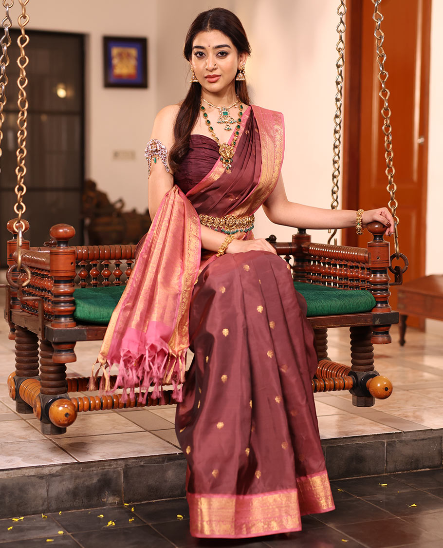 Brown Vasundhara Silk Saree Enriched with Zari Buttas, Complemented by a Contrast Border Featuring Auspicious Pichwai Cow Designs, Elevated with an Intricately Zari-Woven Pallu, and Paired with a Contrast Blouse