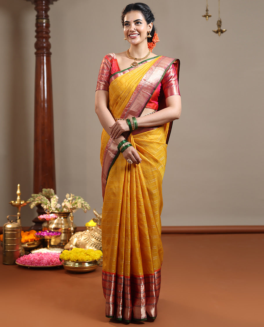 Mustard zari checked Vasundhara silk saree, contrast border of thilakam mokku, chakram, kodi yaanai, kuthirai, and mayil kann designs, intricate pallu, and zari design blouse