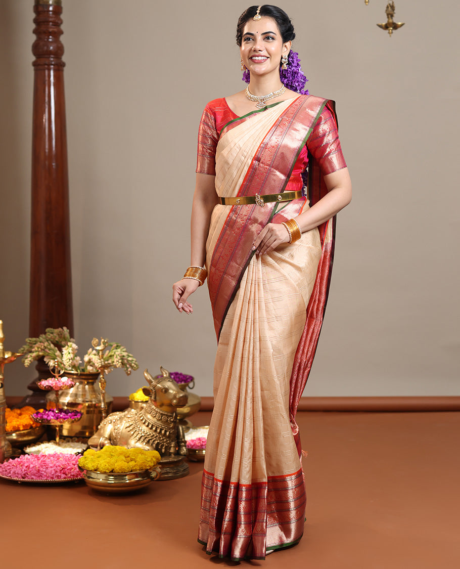 Sandal Vasundhara Silk Saree Subtly Sparkled with Zari Checks, Complemented by a Contrast Border of Thilakam Mokku, Chakram, Kodi Yaanai, Kuthirai, and Mayil Kann, Intricately Designed Pallu, and Paired with a Contrast Blouse
