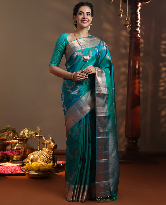 Peacock blue floral jaal jacquard Vasundhara silk mix saree, zari border of thilakam mokku, lavangam, and jaal designs, intricate pallu, and zari design blouse