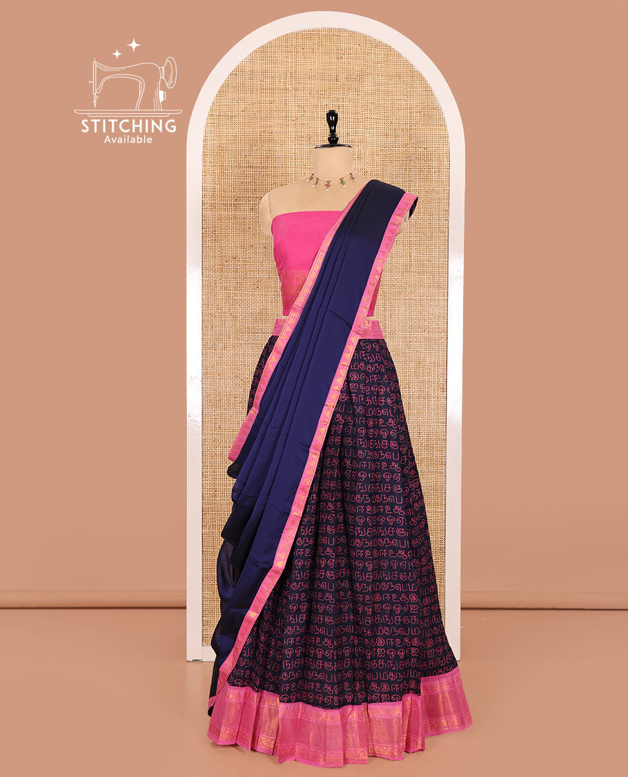 Navy Blue and Pink Printed Sungudi Cotton Half-Saree Showcasing a Skirt Printed with Tamil Letters, Accentuated by a Contrast Traditional Zari Border, a Contrast Blouse, and a Plain Zari-Bordered Dhavani