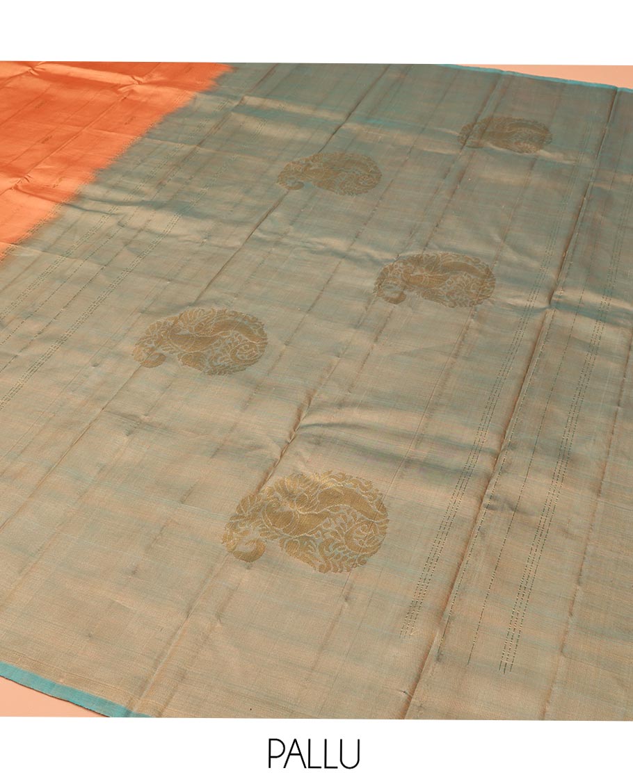 Orange Kanchipuram Silk Saree, Adorned with Zari Buttas All Over Its Body, Complemented by a Contrast  Border of Manga Designs, Pallu of Manga Designs, and Paired with a Contrast Blouse