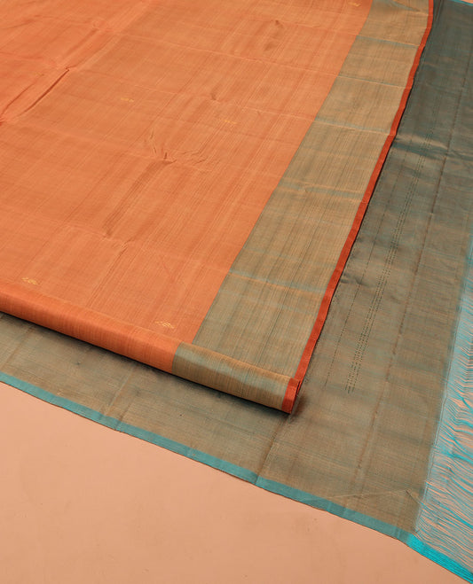 Orange Kanchipuram Silk Saree, Adorned with Zari Buttas All Over Its Body, Complemented by a Contrast  Border of Manga Designs, Pallu of Manga Designs, and Paired with a Contrast Blouse