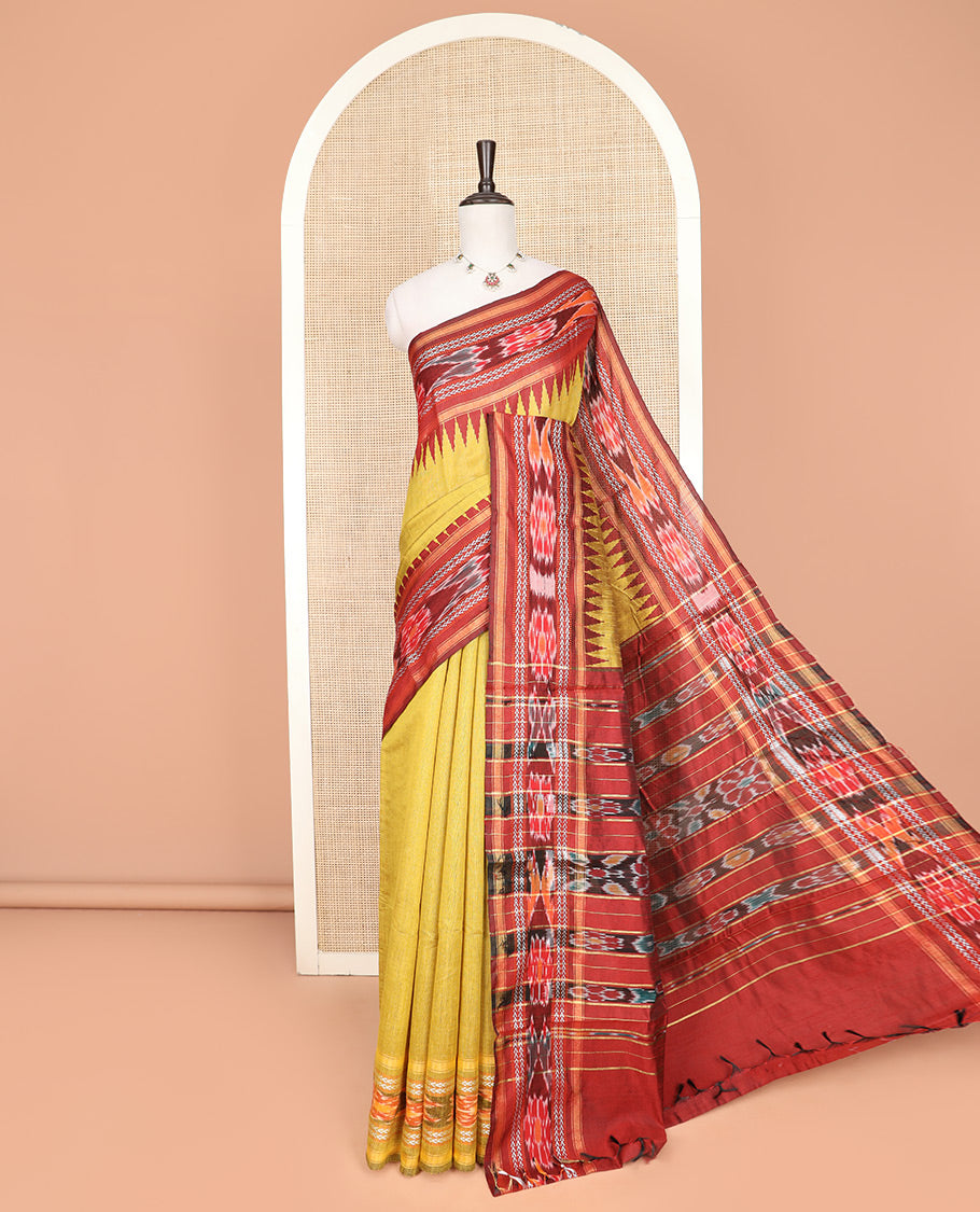 Yellow Plain Dupion Silk Saree, Captivated by a Contrast Temple Border of Geometric Patterns and Ikkat Weave, Pallu Depicting Floral Ikkat Designs, and Paired with a Contrast Blouse