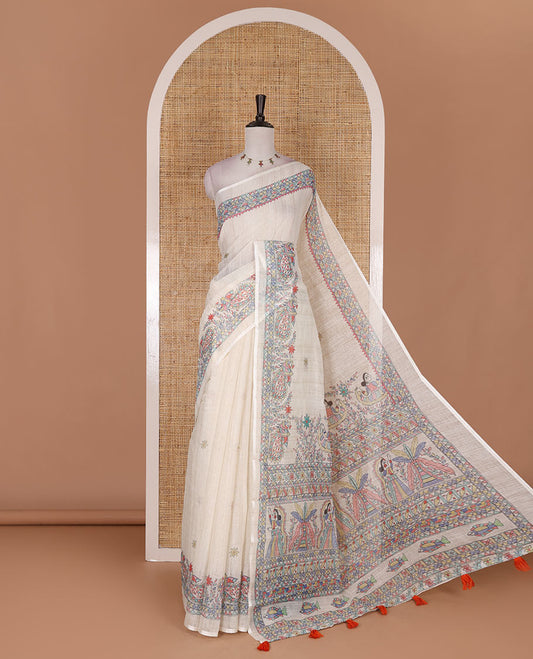 Cream madhubani-style floral buttas printed linen saree, madhubani peacock printed border, madhubani printed pallu, and madhubani village printed blouse
