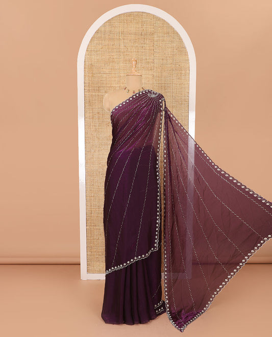 Wine micro-stone work fendy chiffon saree with paisley stone work on its shoulder, a scallop stone work border, a butterfly style pallu, and a matching stone work blouse
