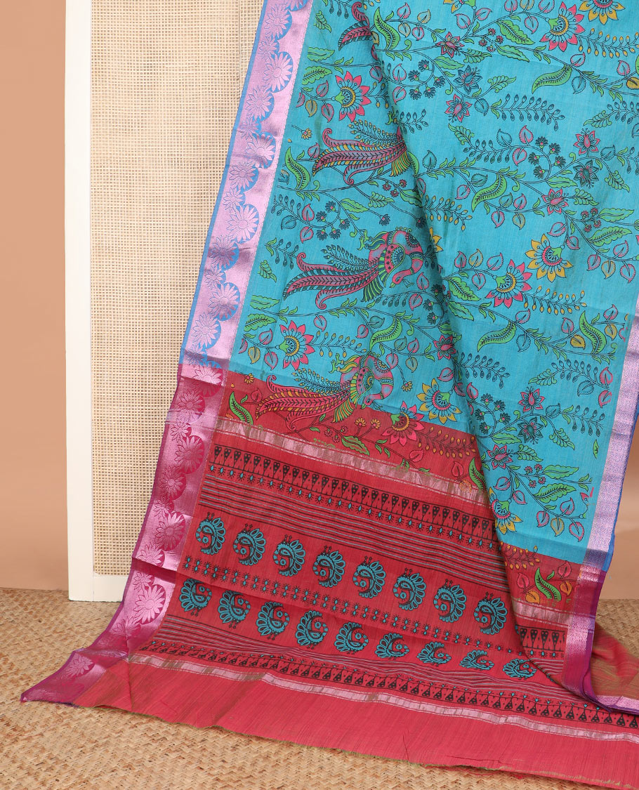 Blue kalamkari style floral vine and peacock printed Andhra cotton saree, rose copper zari floral border, and printed pallu