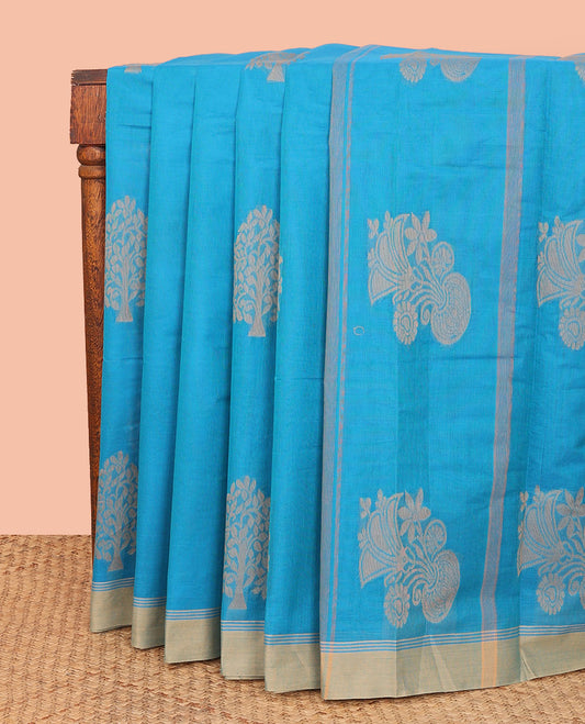 Blue Kanchi Cotton Saree, Bedecked with Tree Buttas All Over Its Body, Complemented by Contrast Border, Pallu Depicts Flower Vase Designs, and Paired with a Matching Blouse