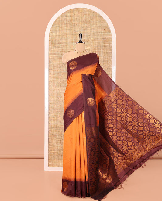 Rust Orange Kanchi Soft Silk Saree, Subtly Sparkled with Zari Buttas All Over Its Body,  Complemented by a Contrast Chakram Motifs Border, an Intricately Designed Pallu, and Paired with a Contrast Blouse
