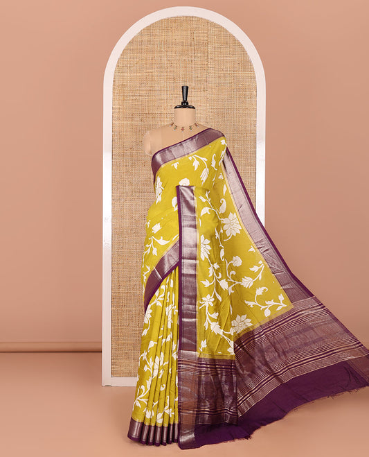 Gold floral and paisley vine ikkat-style discharge printed assam silk saree, contrast chevron design zari border, zari stripes, and a contrast zari bordered blouse