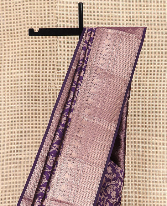 Violet Kanchipuram Silk Saree Spotlighted with Jacquard Design, Highlighted by a Zari Border of Thilakam Mokku, Vanki, Diamond, Kodi Visiry, Iruthalai Pakshi, and Jaal Designs, Pallu Enlivened  with Jaal Designs, and Paired with a Matching Blouse