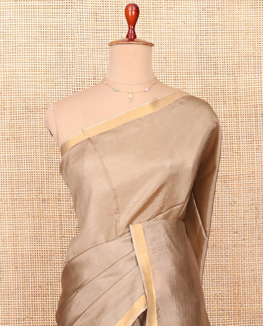Pale Brown Plain Banana Pith Saree, Subtly Made Zari Bavanji Border, Pallu Featuring Zari Stripes, and Paired with a Matching Blouse