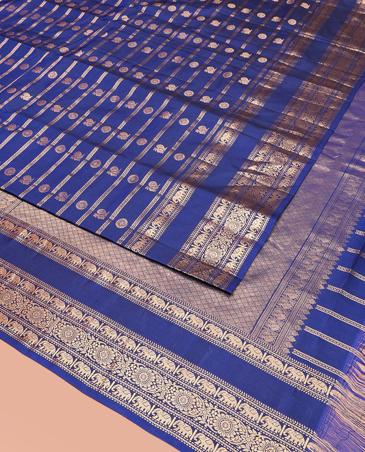 Blue Vasundhara Silk Saree Adorned with Zari Stripes and Annam Chakram Buttas, Highlighted by a Zari Border of Ara Bogudi, Muthu, Banaras, Yaanai, and Chakram Designs, a Zari-Woven Pallu of Jaal Designs, and Paired with a Matching Blouse