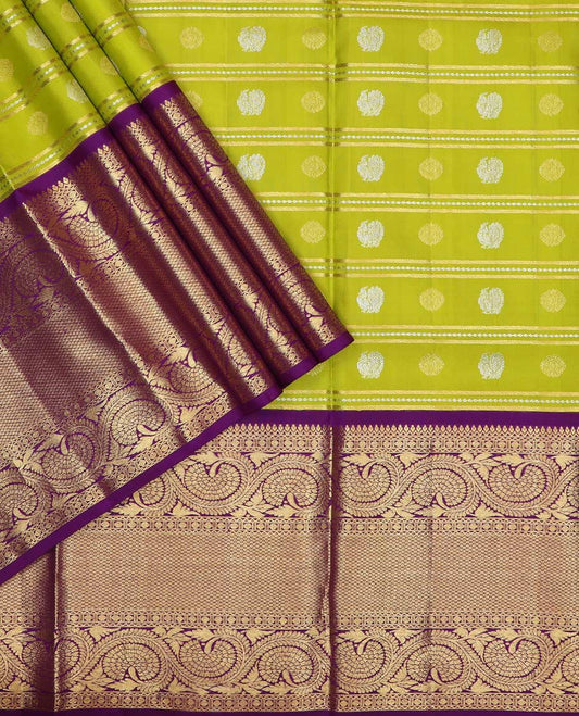 Green pure silk half saree, mayil chakram buttas skirt, contrast blouse of border of thilakam, poun, mayil kann, and dhavana kodi, and arumbu manga design pallu