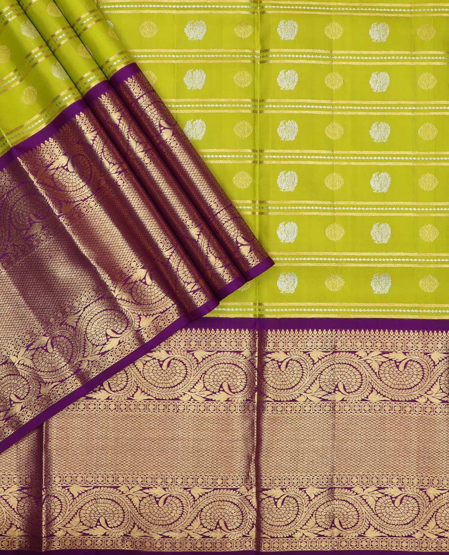 Green pure silk half saree, mayil chakram buttas skirt, contrast blouse of border of thilakam, poun, mayil kann, and dhavana kodi, and arumbu manga design pallu