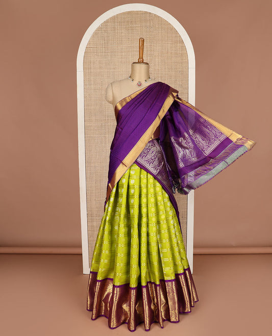 Green pure silk half saree, mayil chakram buttas skirt, contrast blouse of border of thilakam, poun, mayil kann, and dhavana kodi, and arumbu manga design pallu