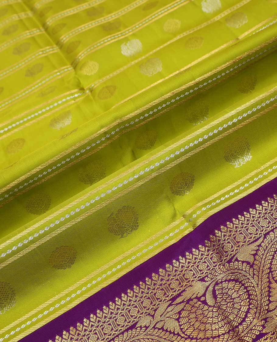 Green pure silk half saree, mayil chakram buttas skirt, contrast blouse of border of thilakam, poun, mayil kann, and dhavana kodi, and arumbu manga design pallu