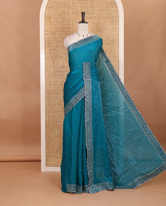 Rama blue Swarovski crystal stone embedded fendy chiffon saree, scallop Swarovski stone embroidered border, and contrast plain blouse