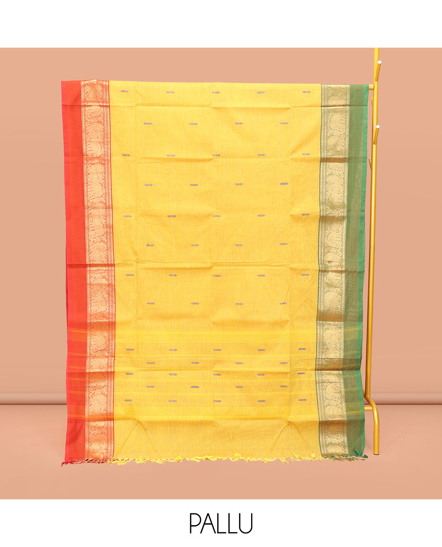 Yellow Chettinad Cotton Saree, Finely Crafted with Thread Buttas All Over Its Body, Complemented by a Contrast Ganga-Jamuna Kal Eragina Border of Kodi Peacock and Elephant Designs, Pallu of Buttas and Stripes, and Paired with a Matching Blouse