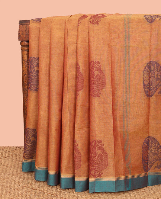 Orange Kanchi Cotton Saree, Beautified with Peacock Buttas All Over Its Body, Complemented by Contrast Border, Pallu Steeped with Flower Vase Designs, and Paired with a Matching Blouse
