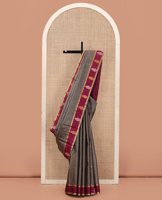 Grey Kanchipuram Silk Saree Enriched with Zari Buttas, Complemented by a Contrast Border of Zari Designs, Zari Pallu of Zari Buttas, and Paired with a Contrast Blouse