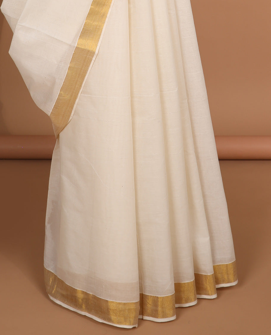 Cream kerala saree with zari design, plain border & pallu of intricate designs