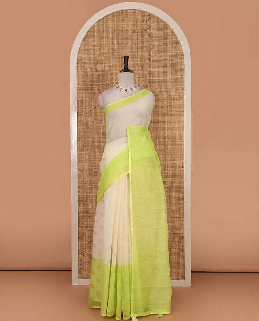Cream full-plain linen saree, contrast parrot green big plain border, plain pallu & buttas printed matching blouse