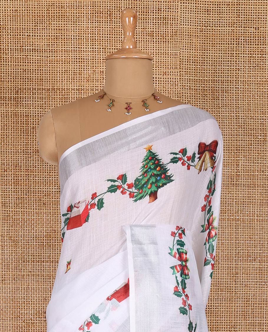 White jingle bell and Christmas tree motifs printed linen saree with bavanji borders, Santa Claus figure printed pallu, and a contrast jingle bell printed blouse