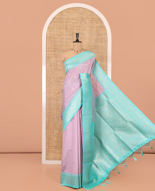 Dusky Pink-Lavender Elite Soft Silk Saree, Adorned with Zari Buttas, Complemented by Contrast Traditional Zari Border, Intricate Pallu and a Contrast Blouse