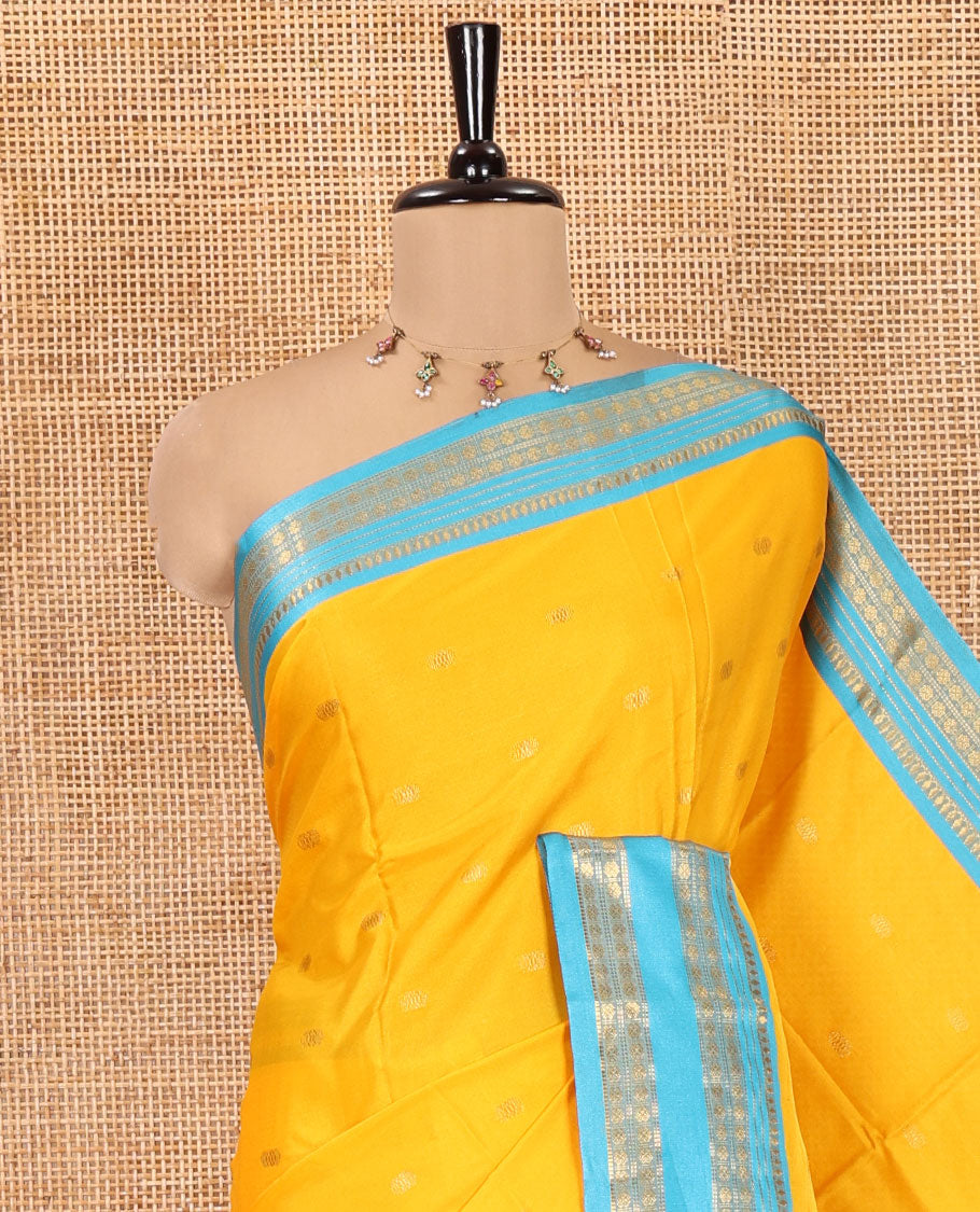 Yellow Softy Silk Saree, Bedecked with Zari Buttas, Contrast Traditional Rettai Pettu Border, and a Contrast Blouse