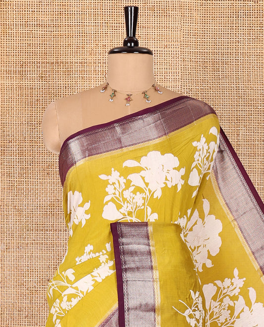 Gold floral motifs silhouette-style discharge printed assam silk saree, contrast chevron design zari border, zari stripes, and a contrast zari bordered blouse