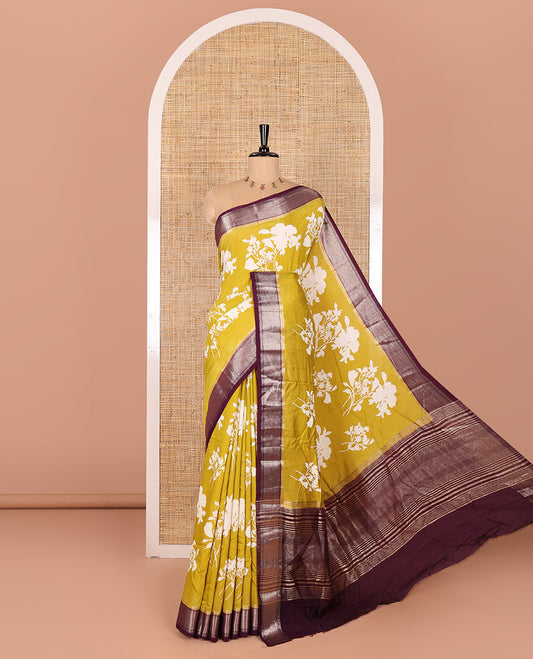 Gold floral motifs silhouette-style discharge printed assam silk saree, contrast chevron design zari border, zari stripes, and a contrast zari bordered blouse