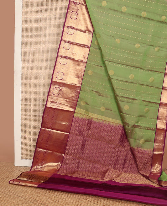 Green vasundhara elite silk saree with zari buttas, contrast getti zari border of round mayil designs & pallu of jaal design