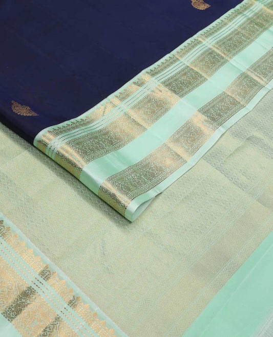 Blue zari buttas Vasundhara silk mix saree, contrast rettai pettu border of thilakam, muthu, neli, and mayil designs, and intricate pallu