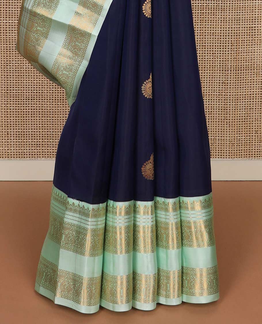 Blue zari buttas Vasundhara silk mix saree, contrast rettai pettu border of thilakam, muthu, neli, and mayil designs, and intricate pallu