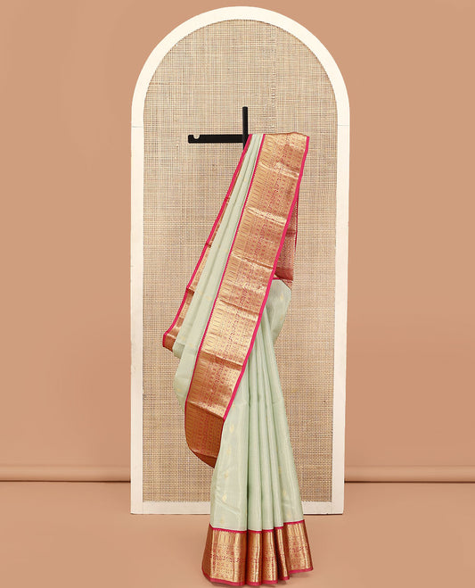 Pale Green Vasundhara Lite Silk Mix Saree, Enriched with Zari Buttas and Stripes on Its Body, Complemented by a Contrast Border of Kathir, Kodi Manga, and Rudraksham Mayil Designs, Majestically Detailed Pallu, and Paired with a Contrast Blouse
